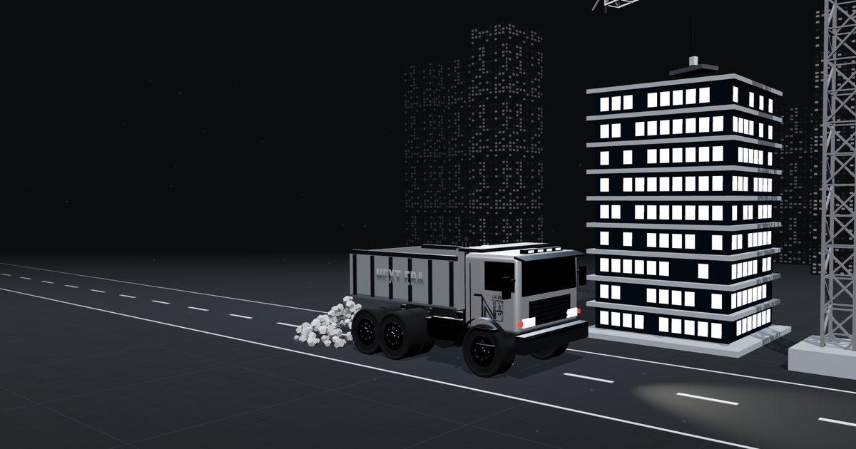Night construction site with a dump truck and a lit tower